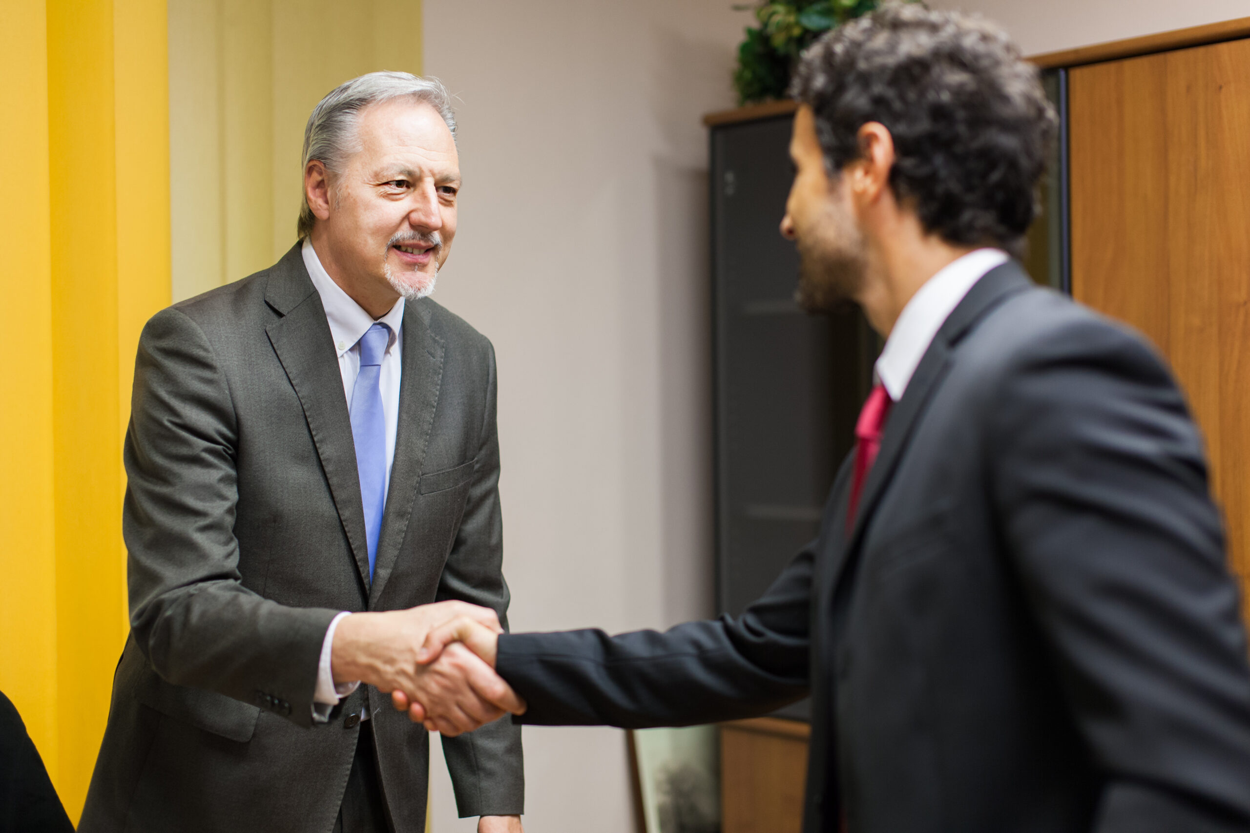 Businessman,Welcoming,A,Guest,In,His,Office
